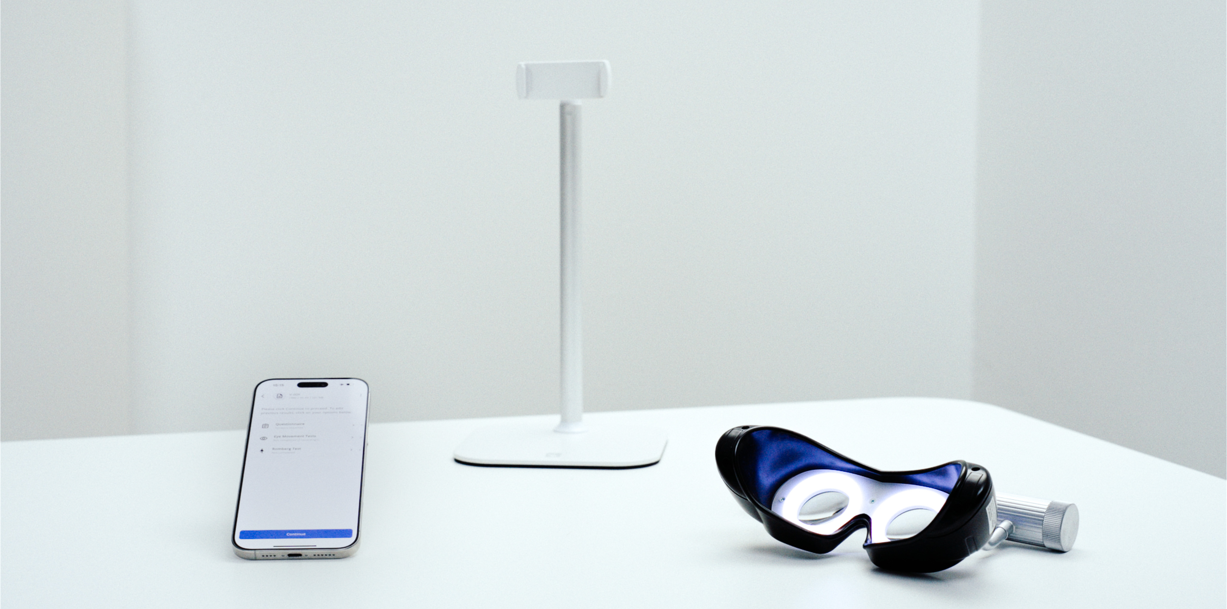 Dizziness exam kit with VertifyMed app, Frenzel goggles, and phone stand