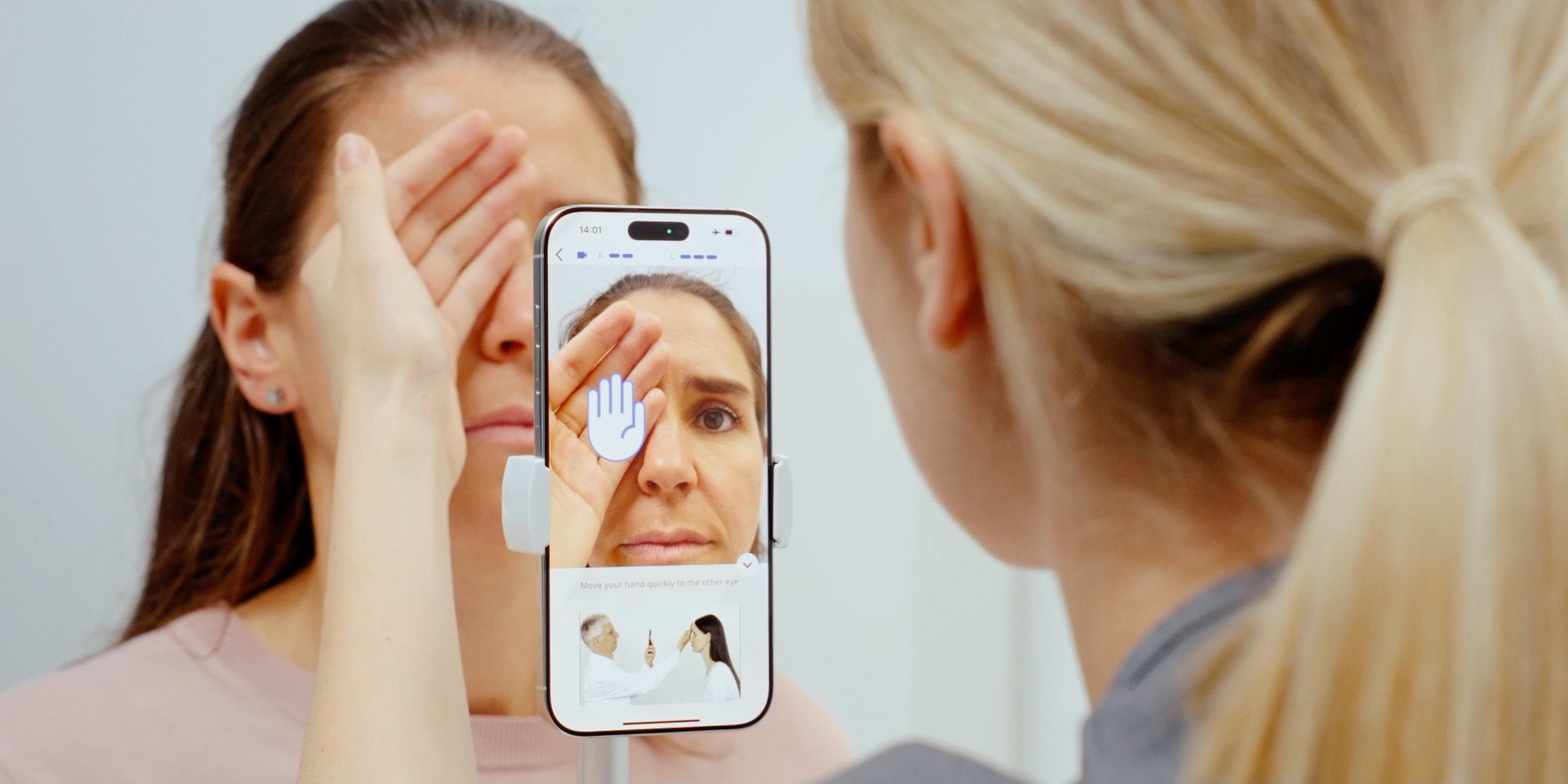 Clinician guiding a patient through a VertifyMed eye exam via smartphone
